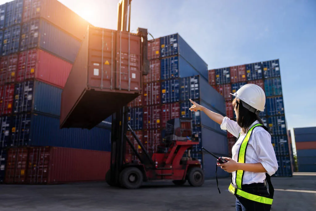 Woman Foreman control loading Containers box